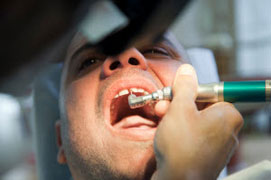 A dentist helping a patient